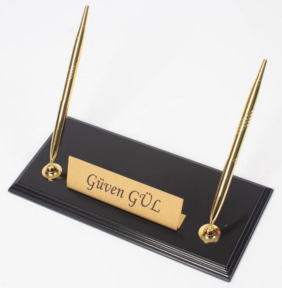 gold pens with black wooden stand