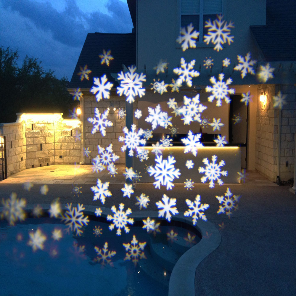 Projection of snow flakes on the wall of the house