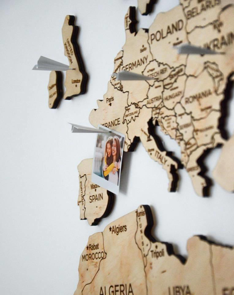 wooden map on wall continents color light wood