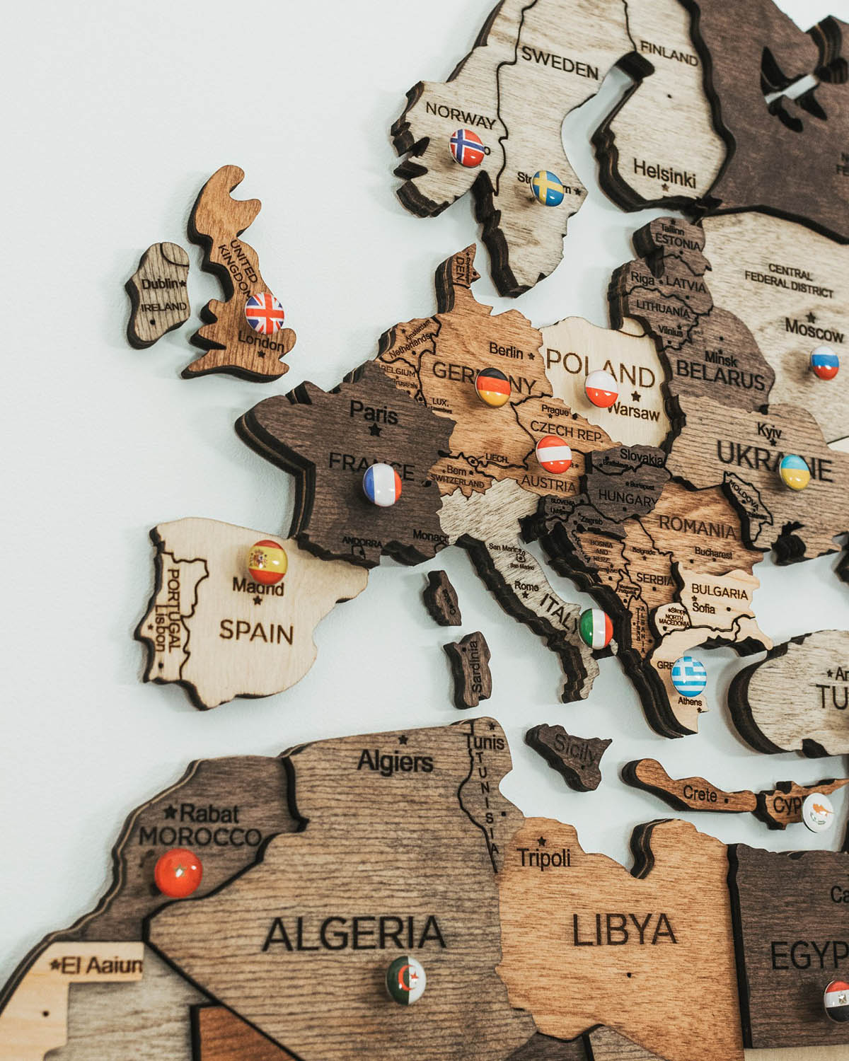 push pins onto a wooden map - state flags